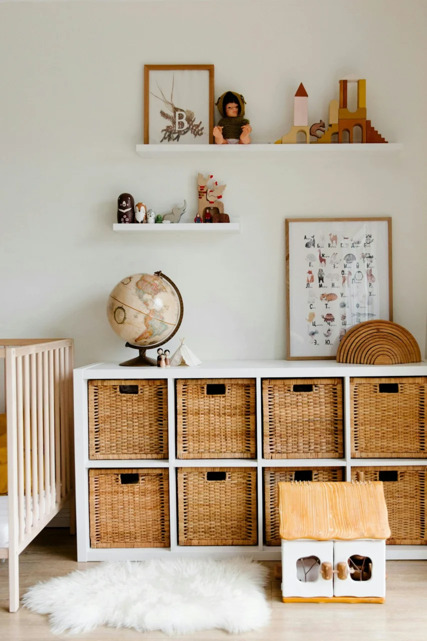 A baby's room with a crib, dresser, and crib bed