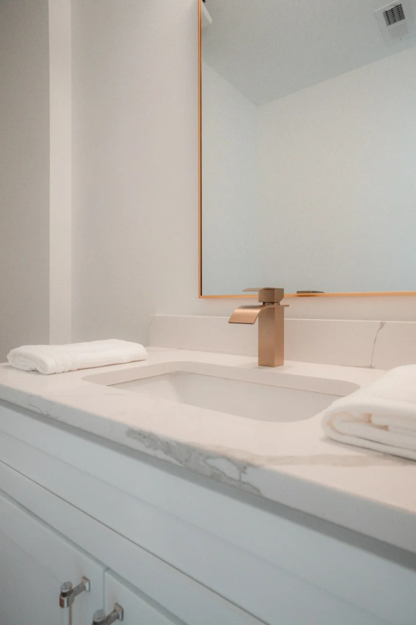 A bathroom sink with a large mirror above it