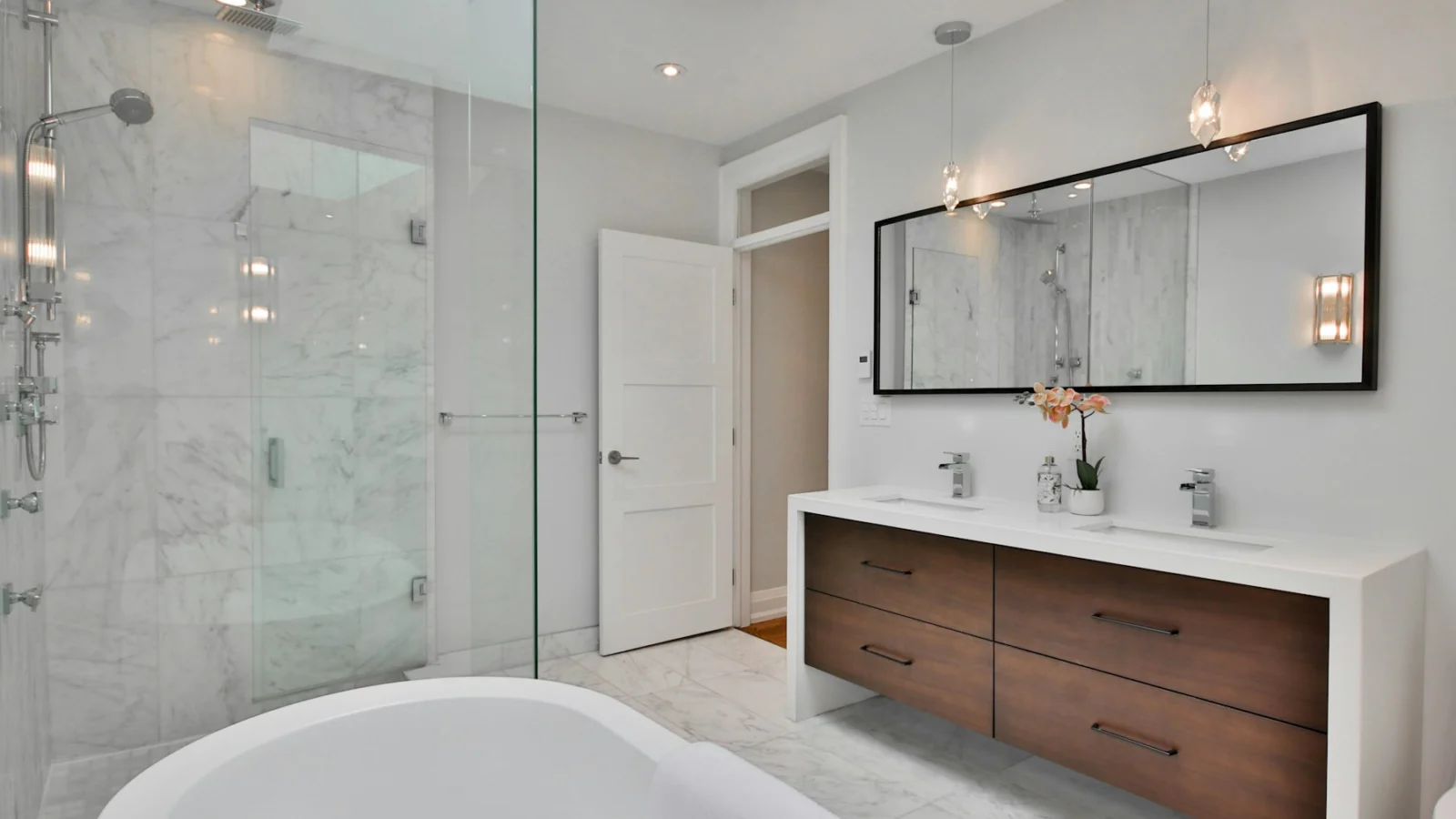 a bathroom with a large white bathtub next to a walk in shower