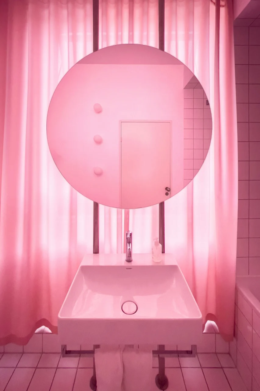 a bathroom with a sink, mirror and bathtub