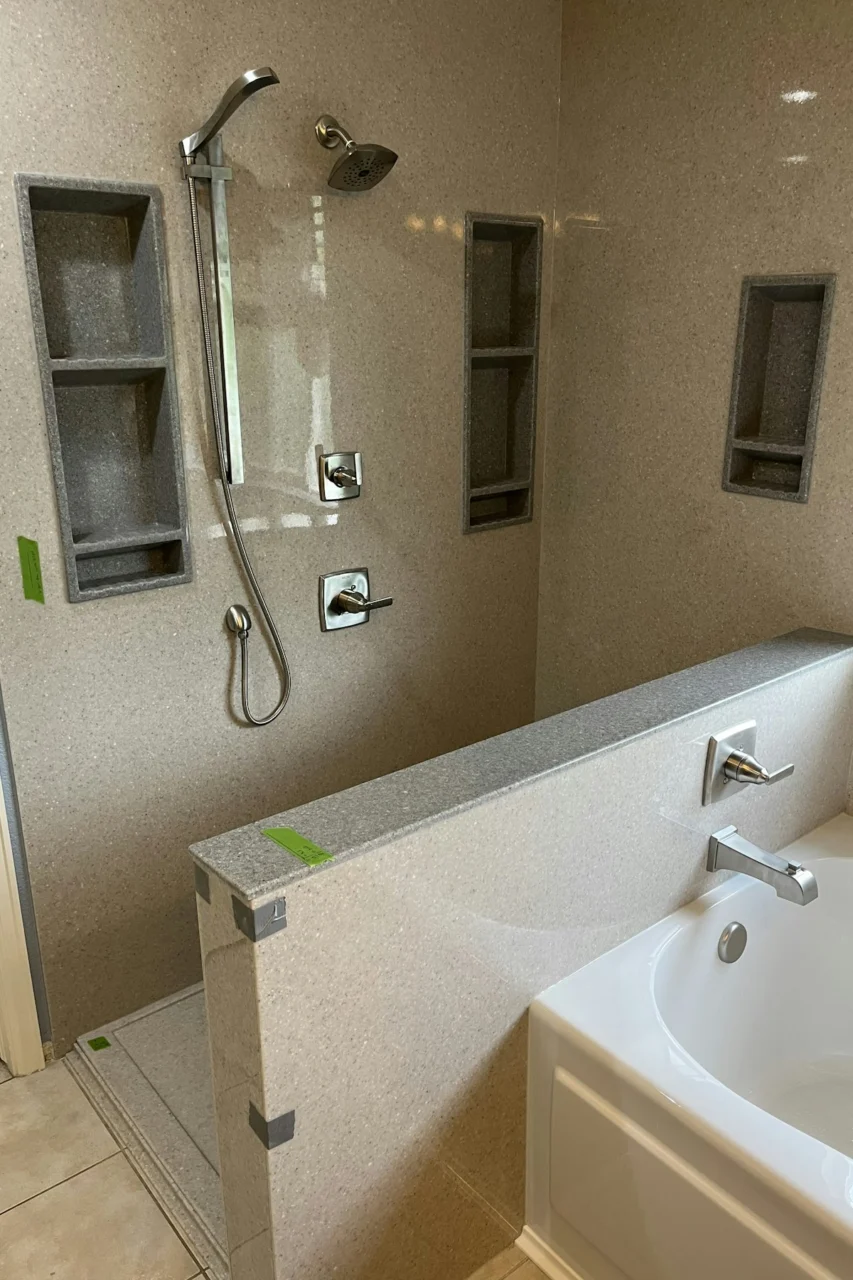 a bathroom with a sink, shower, and bathtub