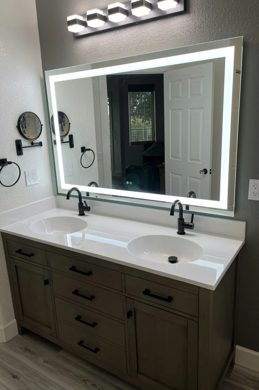 a bathroom with two sinks and a large mirror