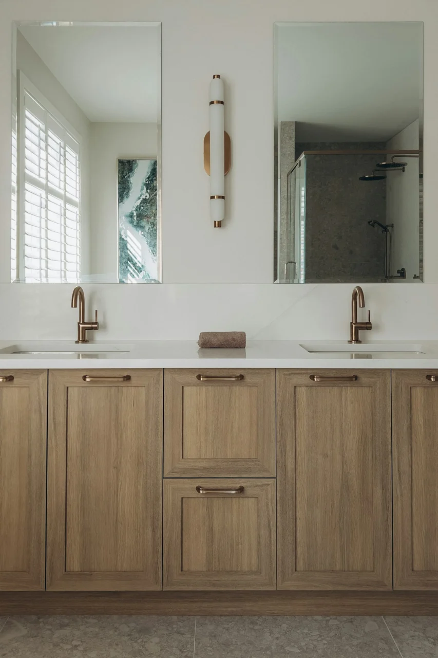 a bathroom with two sinks and a large mirror