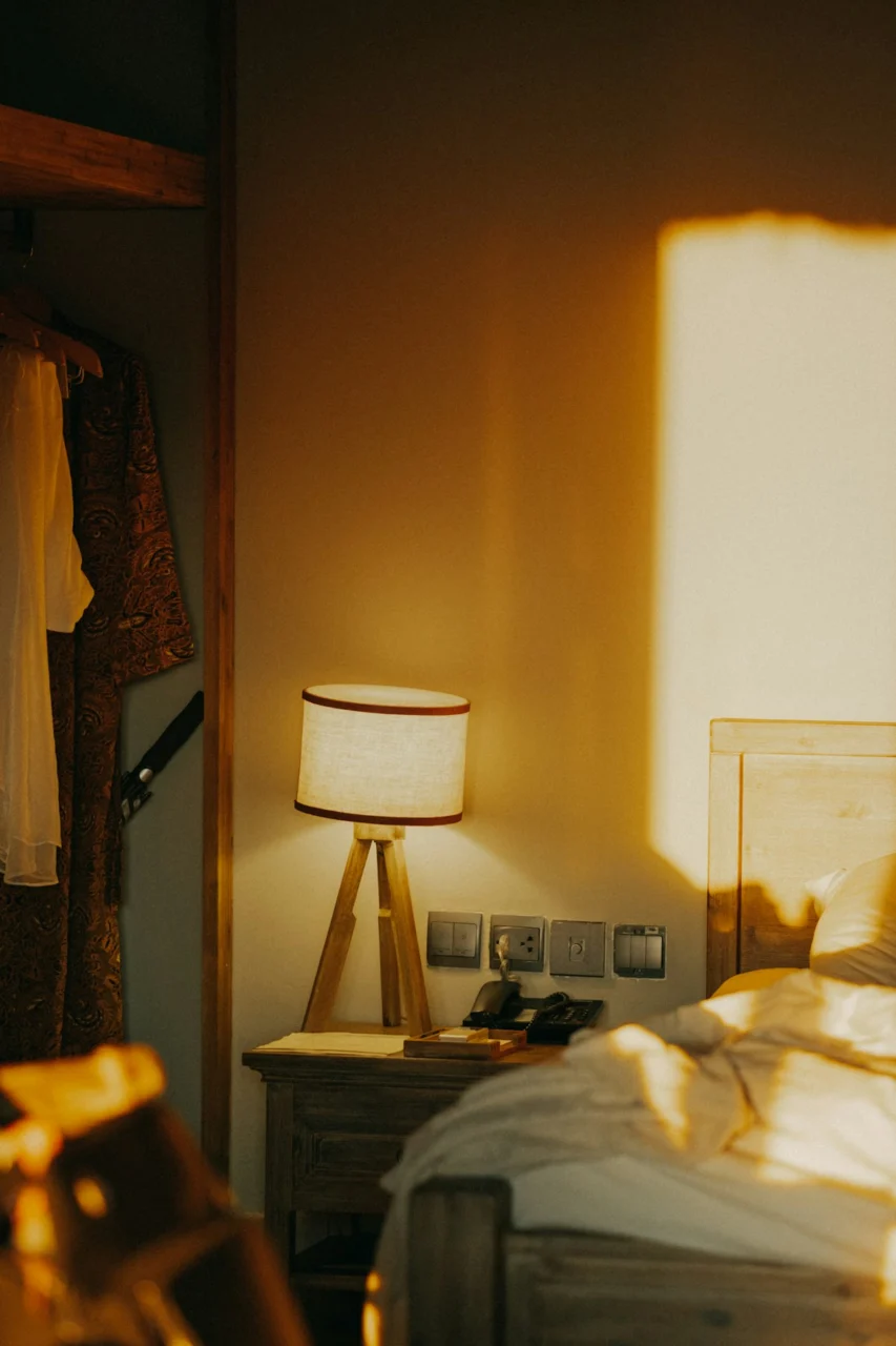 a bedroom with a bed and a lamp