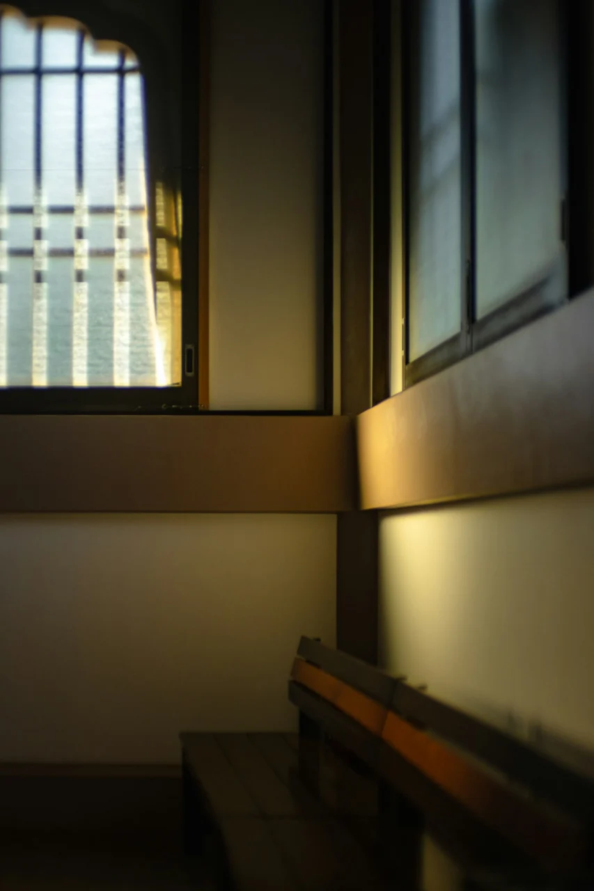 A bench sitting in front of a window