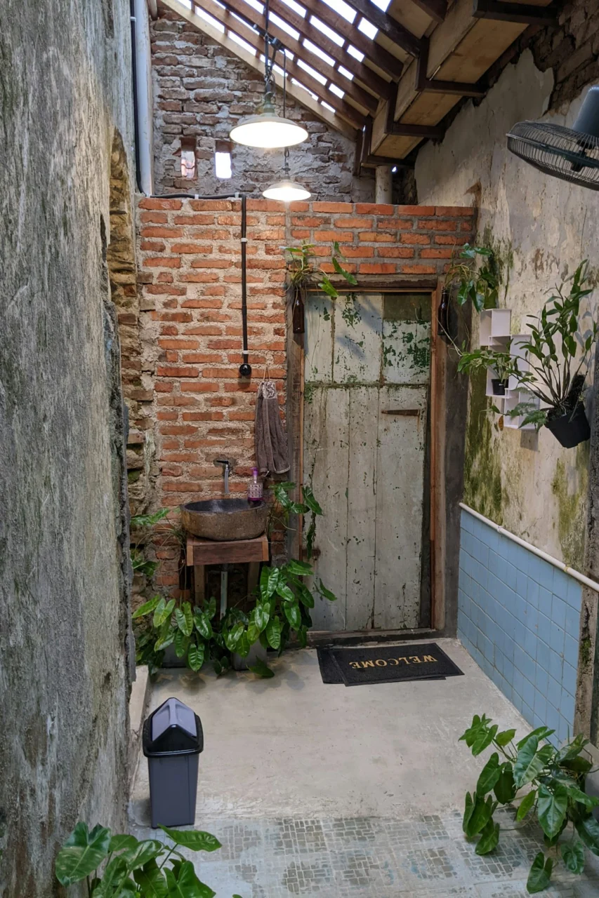 a brick building with a sink and a door