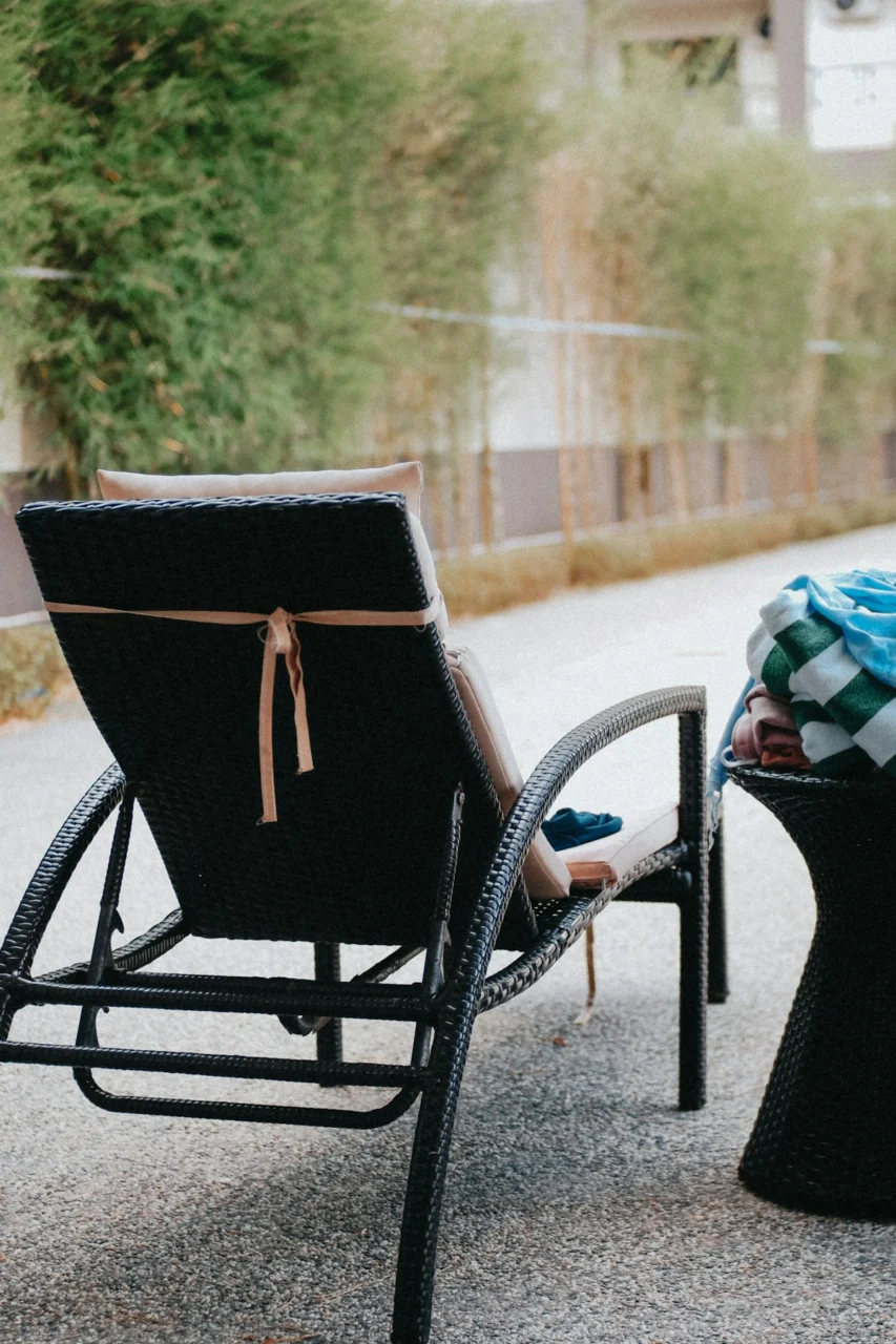 a chair and a table sitting on the side of a road