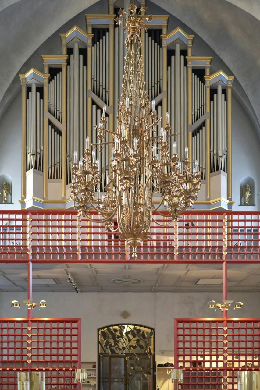a chandelier hanging from the ceiling of a church