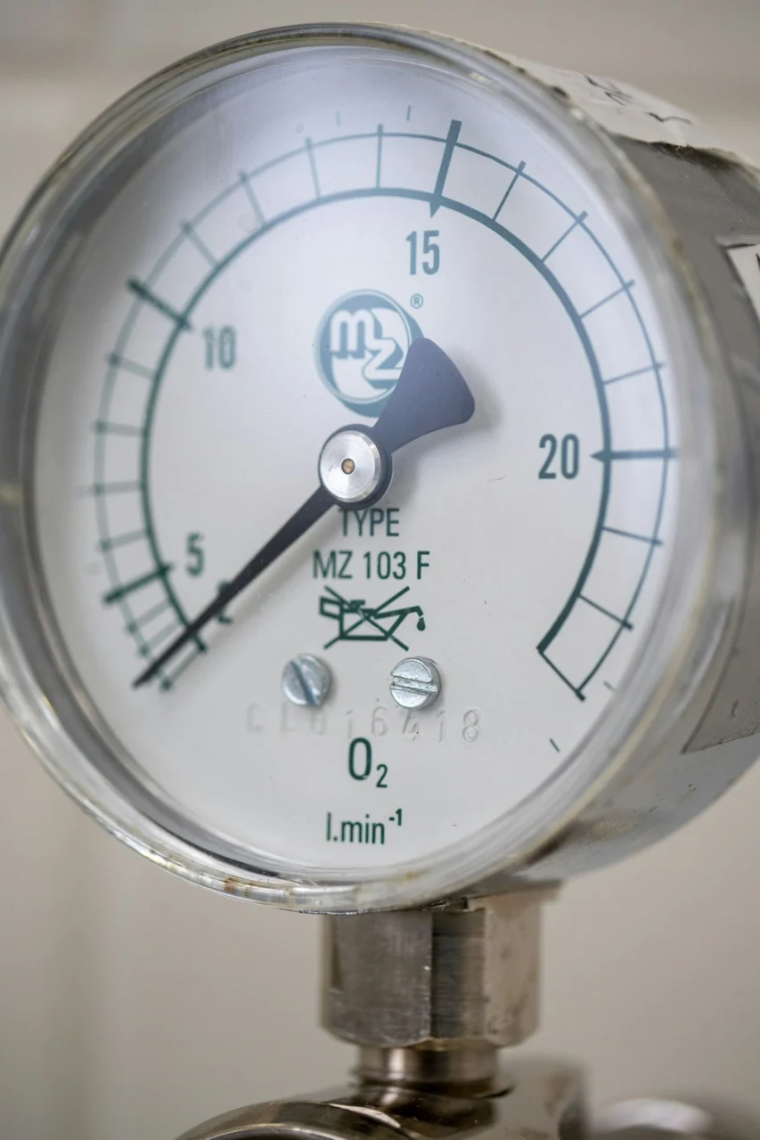 A close up of a pressure gauge on a pipe
