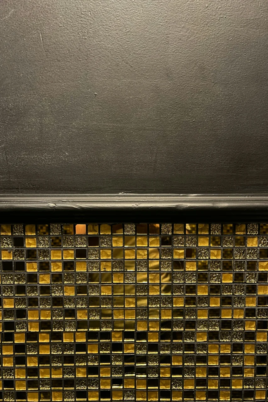 a close up of a wall with a yellow and black pattern