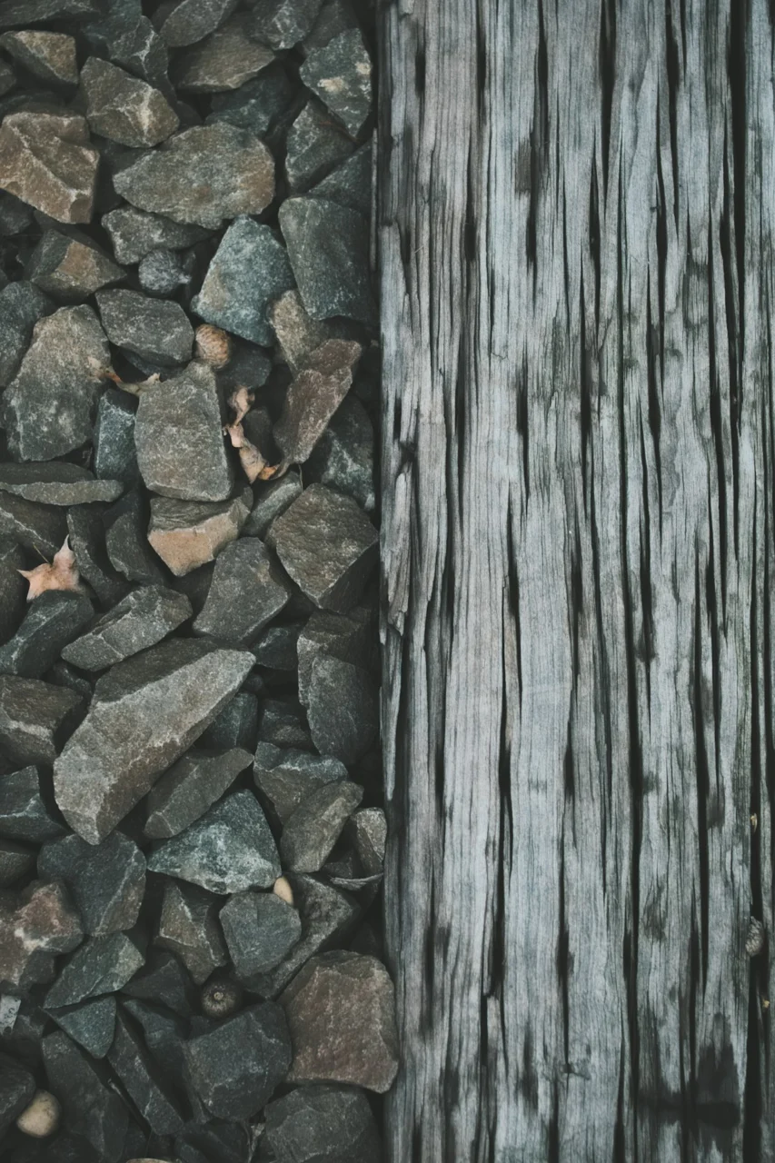 a close up of rocks near a wooden post