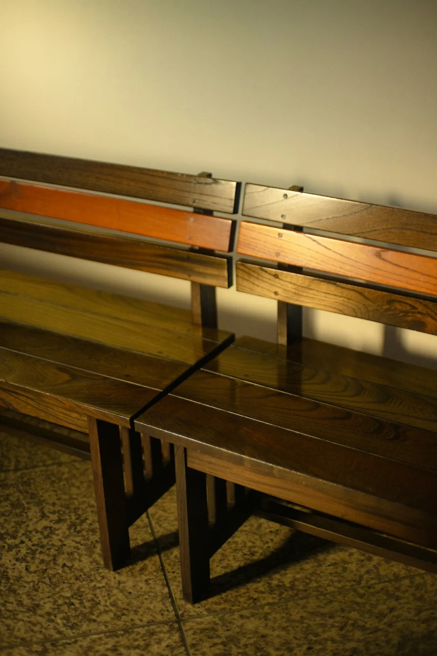A couple of wooden benches sitting next to each other
