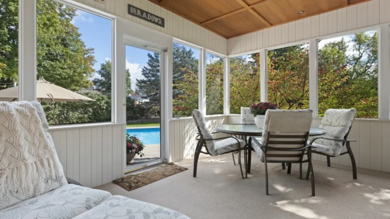 a covered patio with a table and chairs