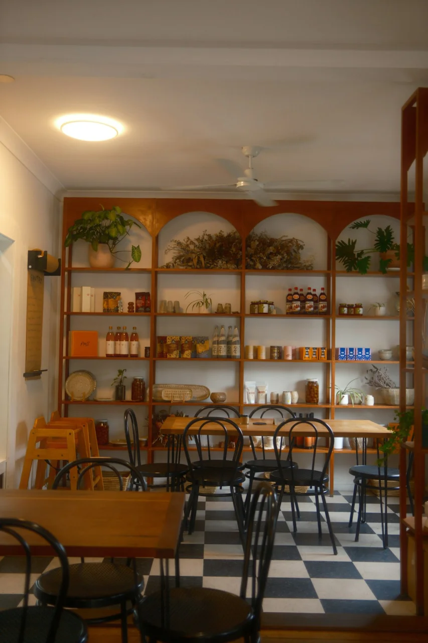 A cozy cafe with shelves full of products