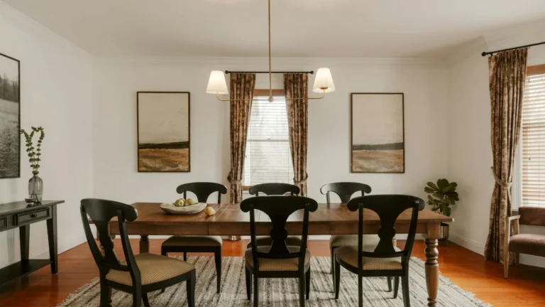 A formal dining room with a wooden table and chairs