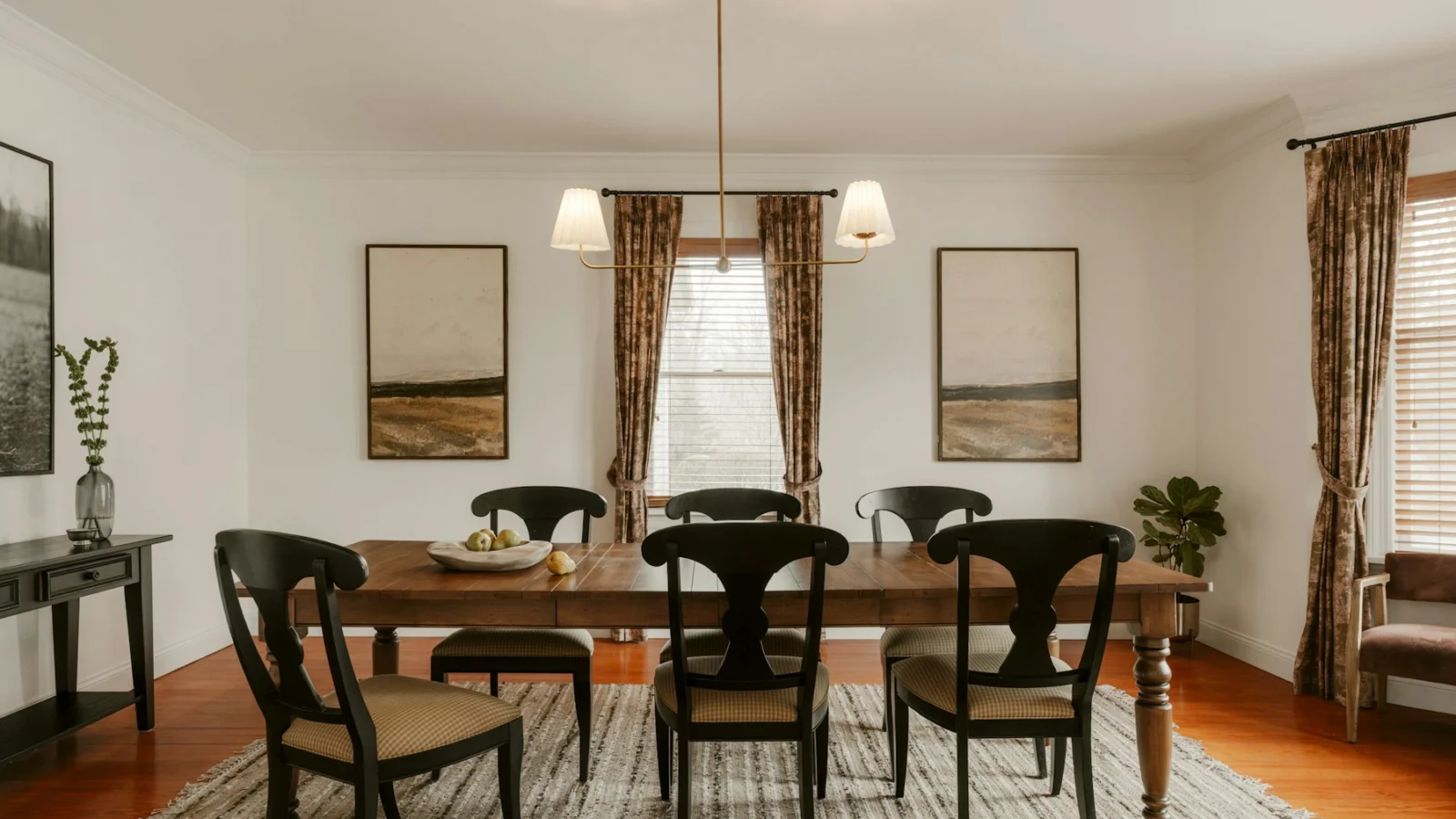 A formal dining room with a wooden table and chairs