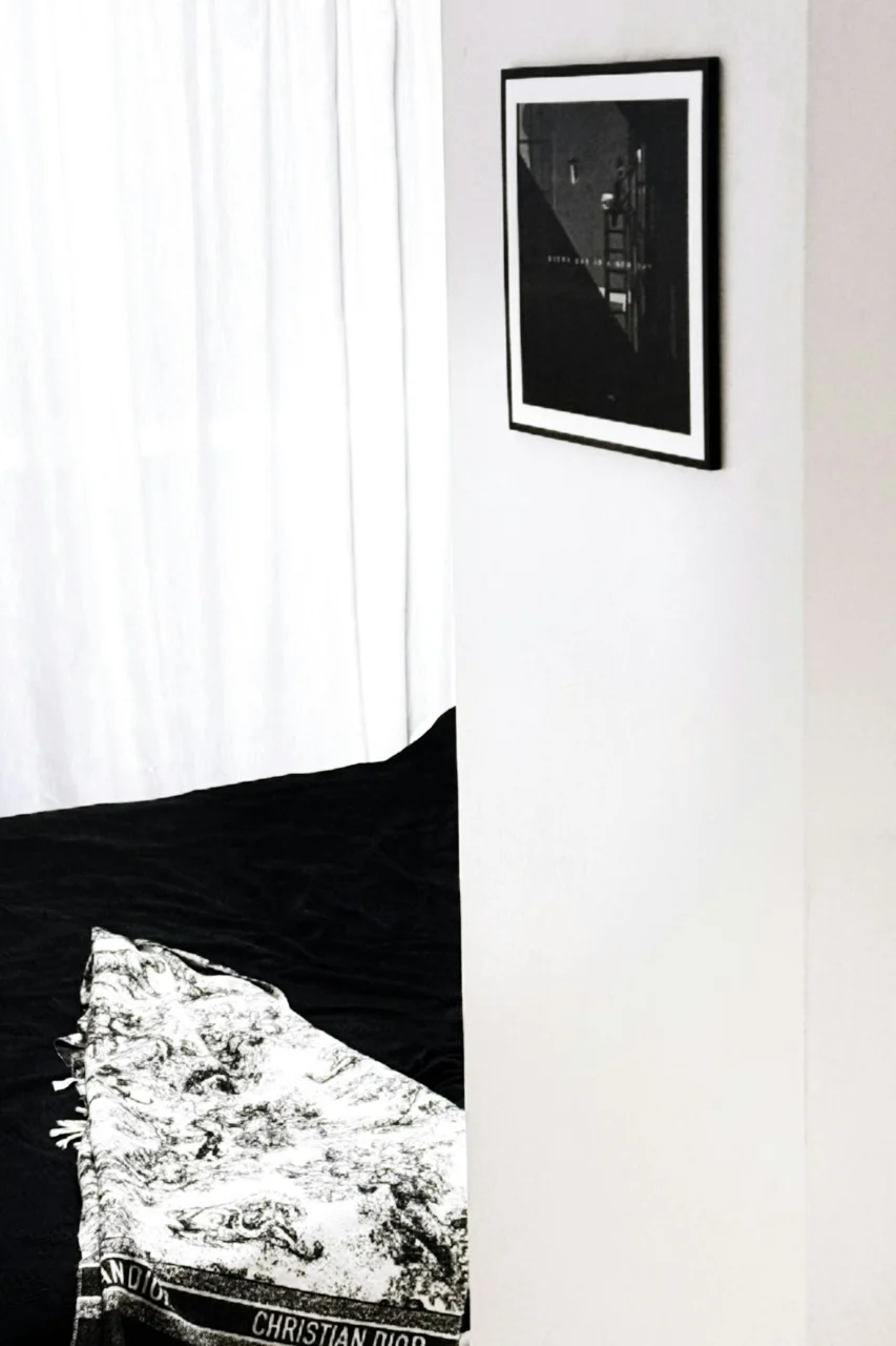 A framed artwork hangs above a bed