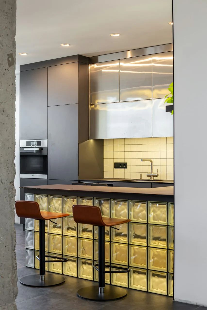 A kitchen with a counter and two stools