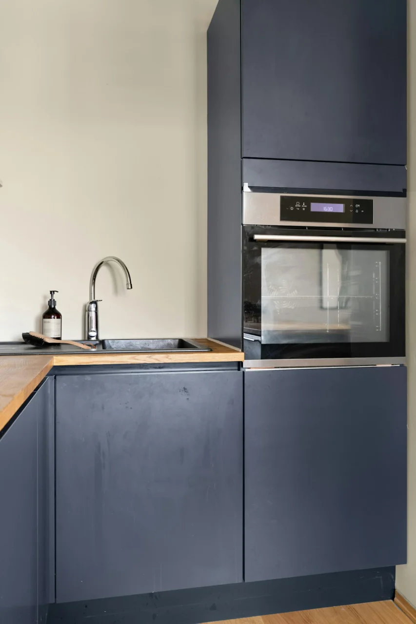 A kitchen with a sink, oven and counter top