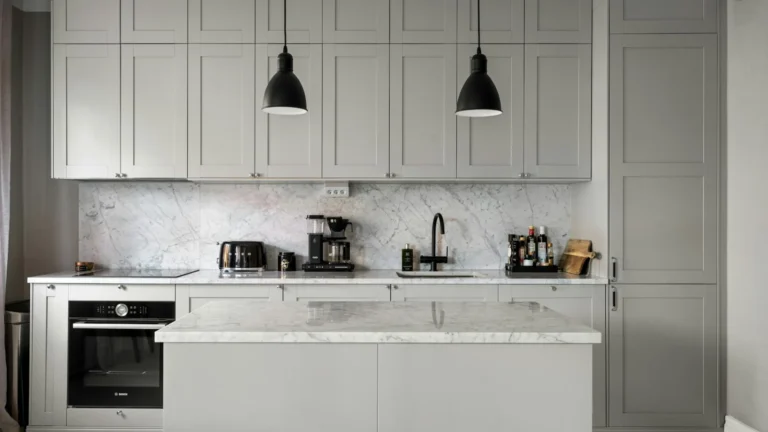 A kitchen with a stove, sink, and oven