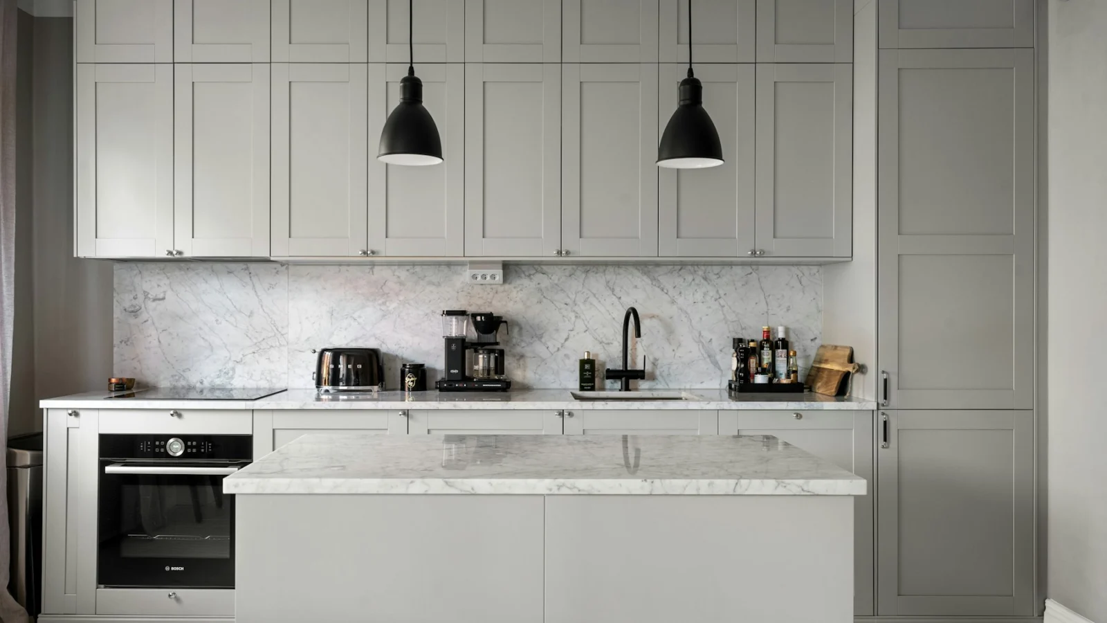 A kitchen with a stove, sink, and oven