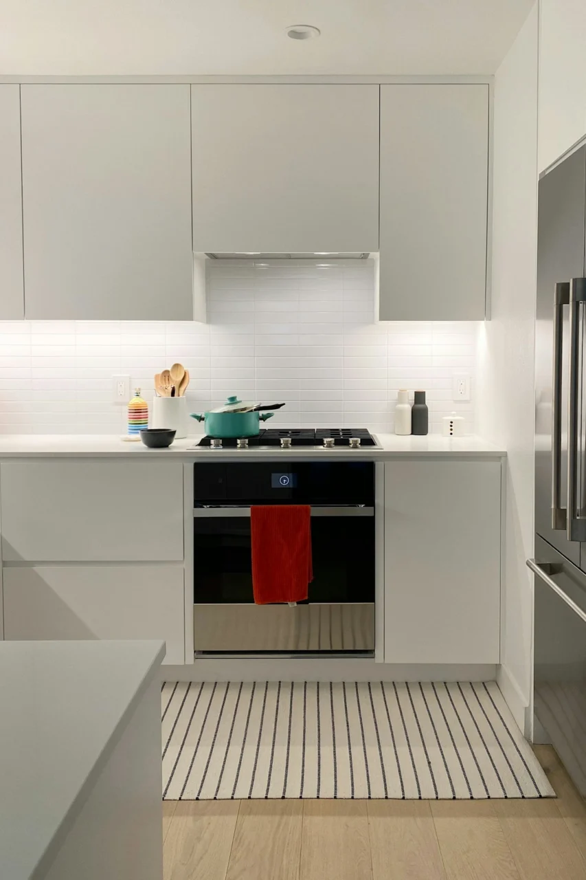 A kitchen with white cabinets