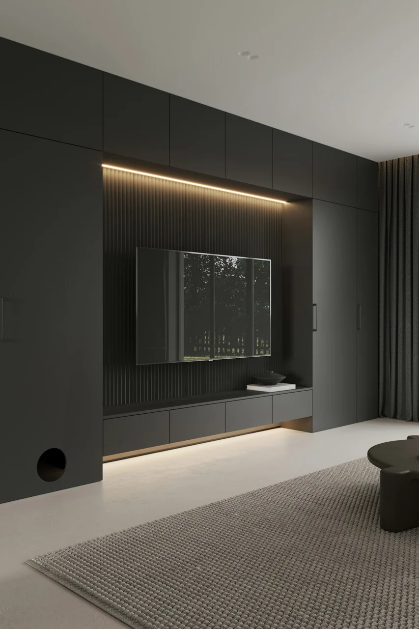 A living room with a couch, coffee table and television