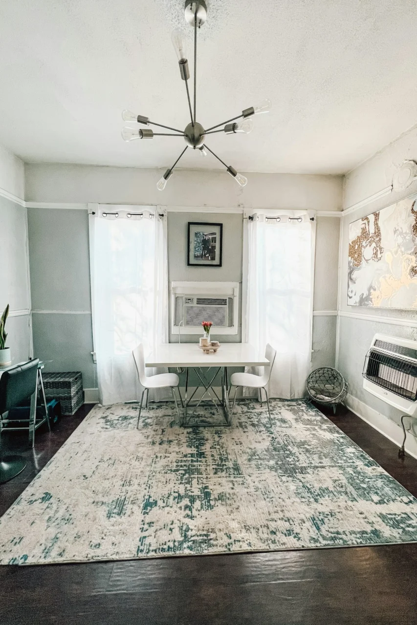 a living room with a rug and a table