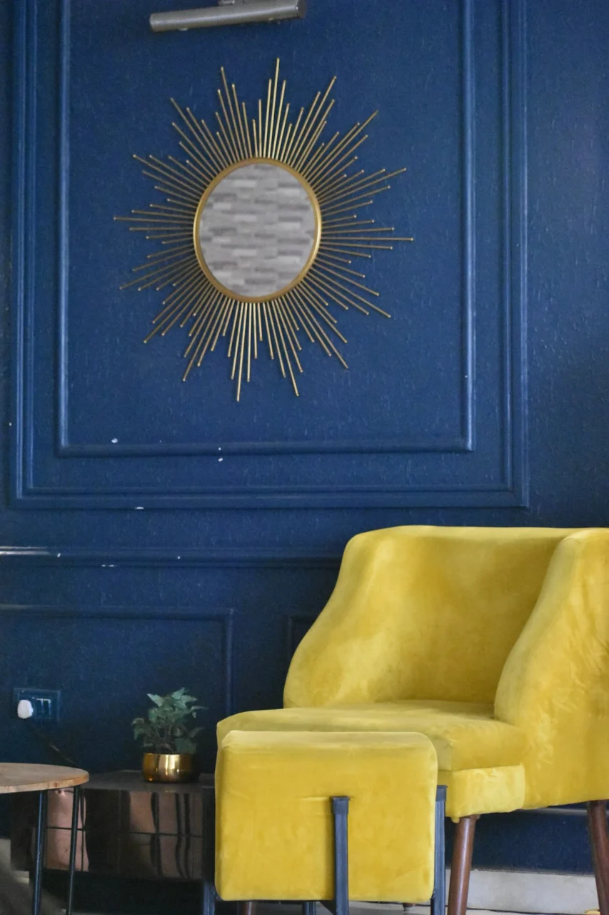 a living room with blue walls and a yellow chair