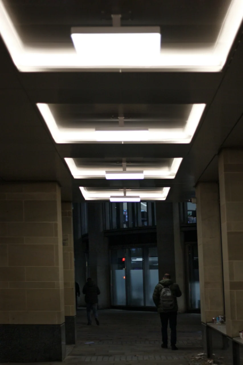 a man and woman walking through a hallway