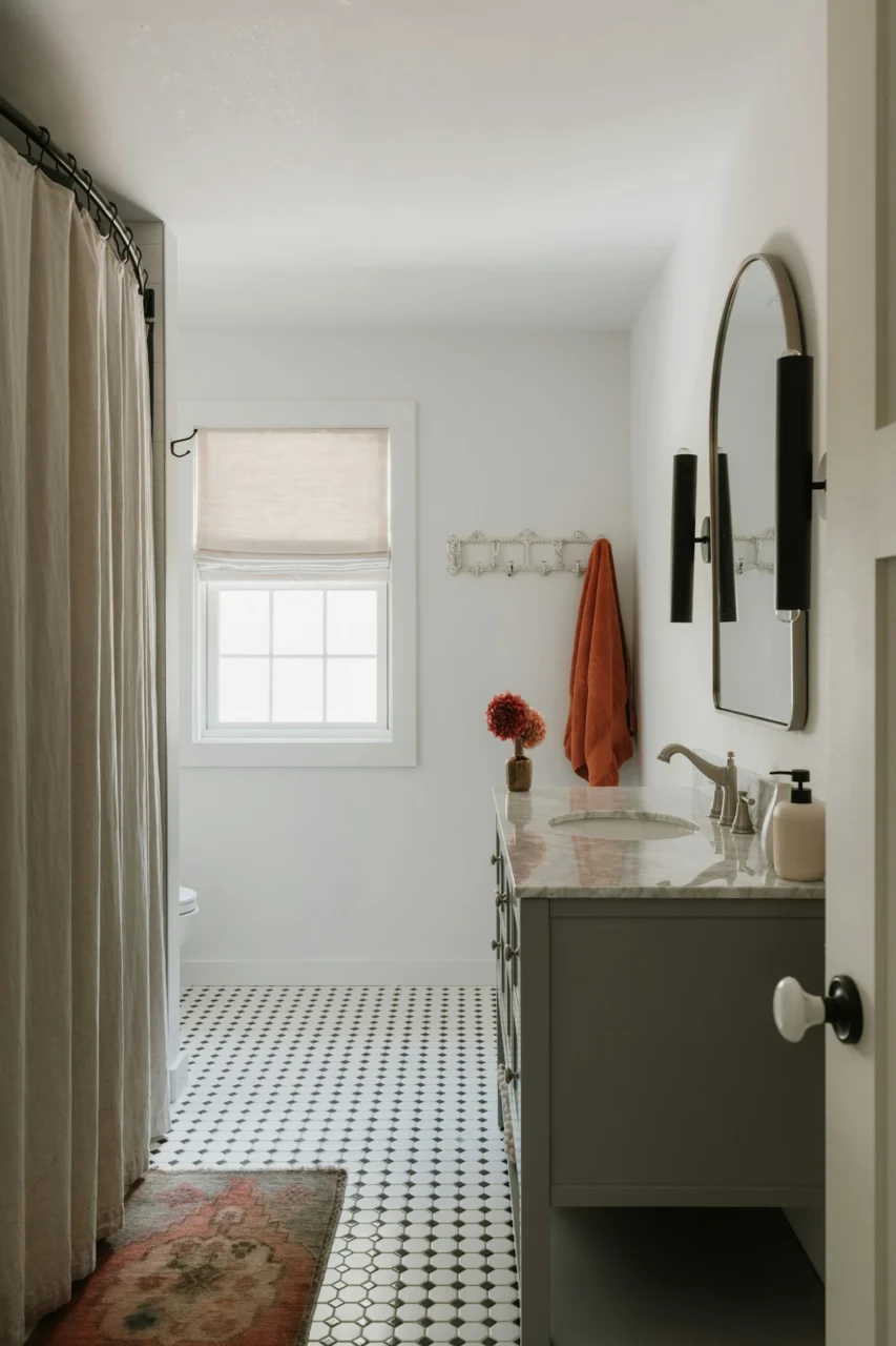 A modern bathroom with a vanity and tiled floor