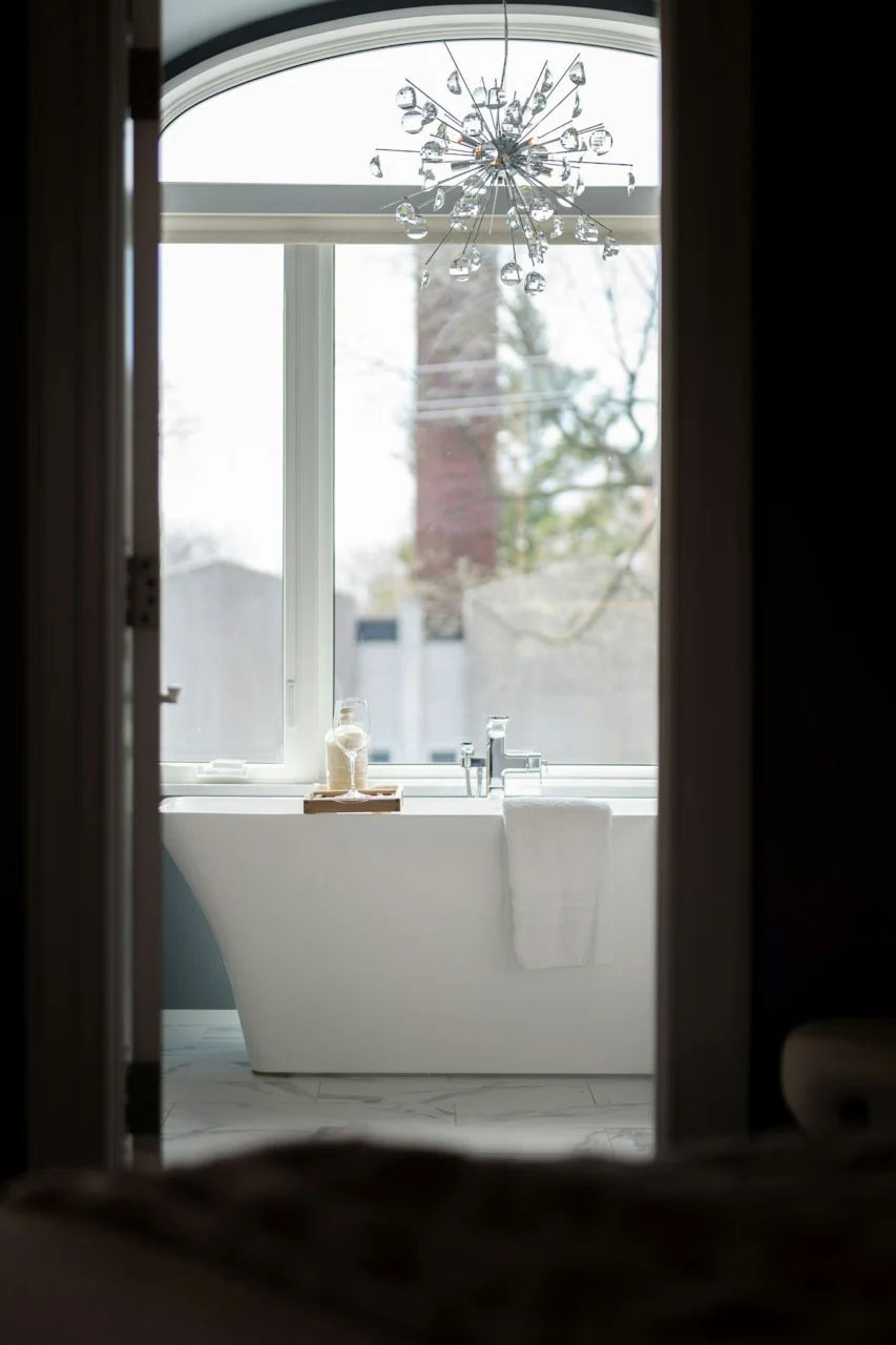 A modern freestanding bathtub with a large window