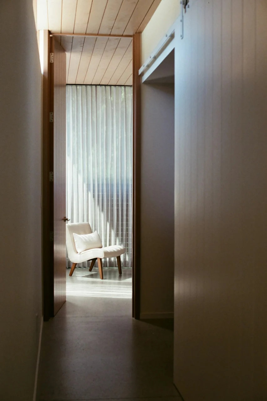 A modern hallway with a chair by the window