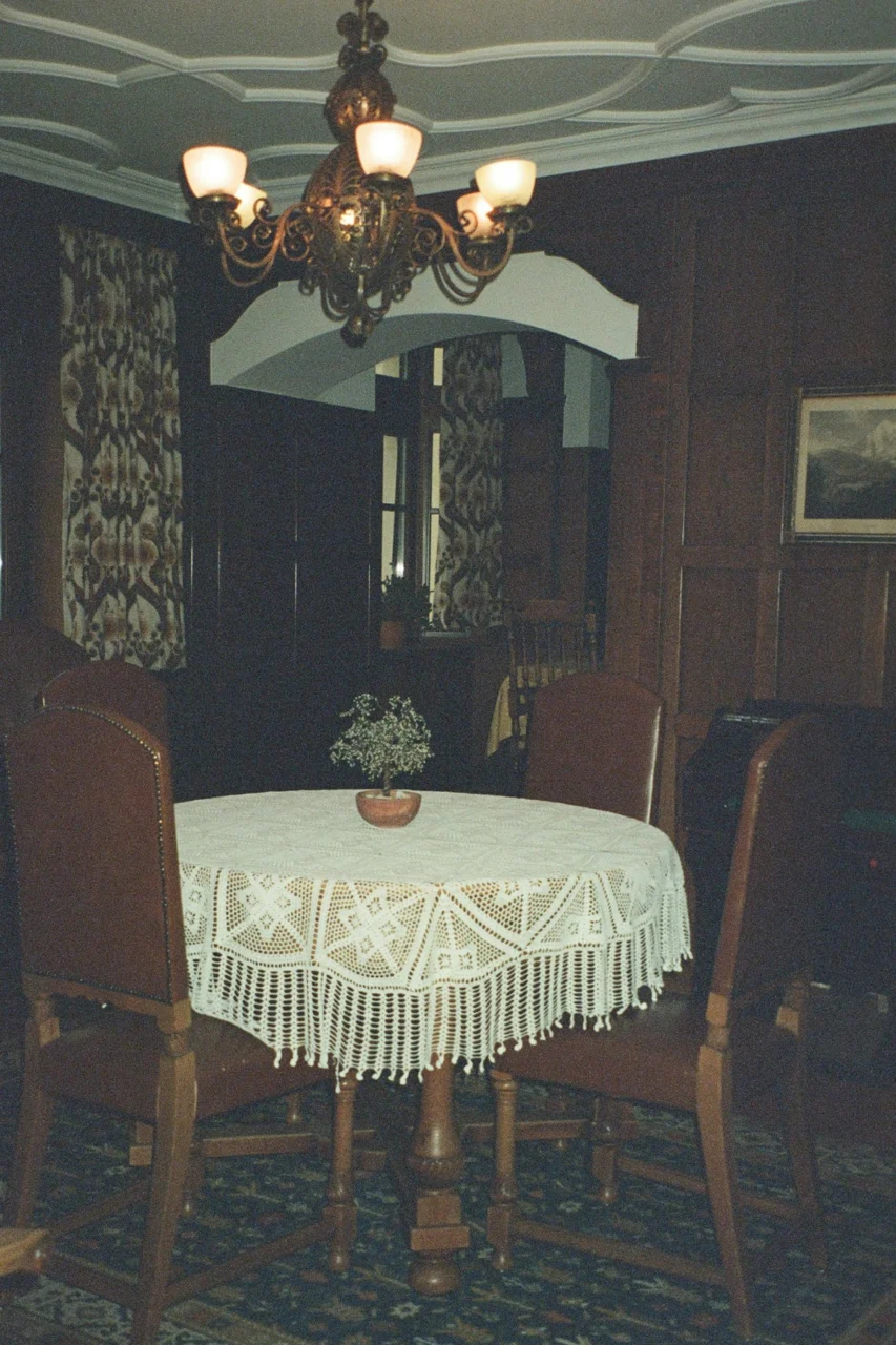 A round table with chairs in a dimly lit room