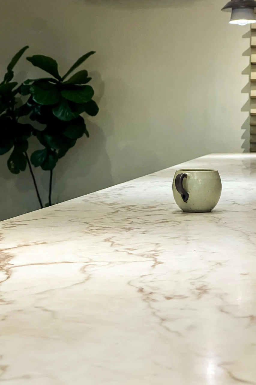 A single mug sits on a marble countertop