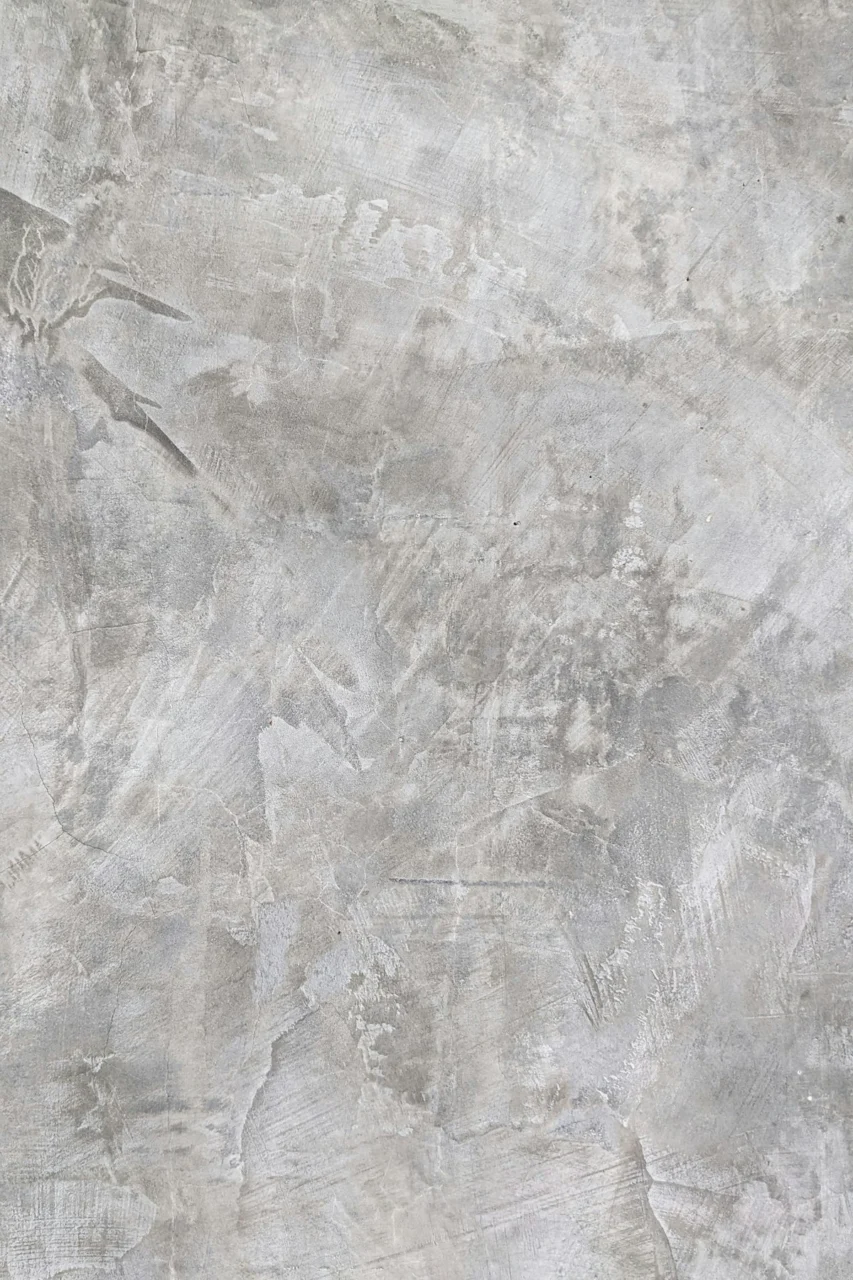 A smooth grey concrete wall with subtle trowel marks and natural texture