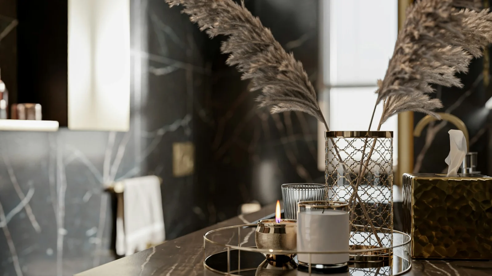 a table topped with a candle and a vase filled with flowers