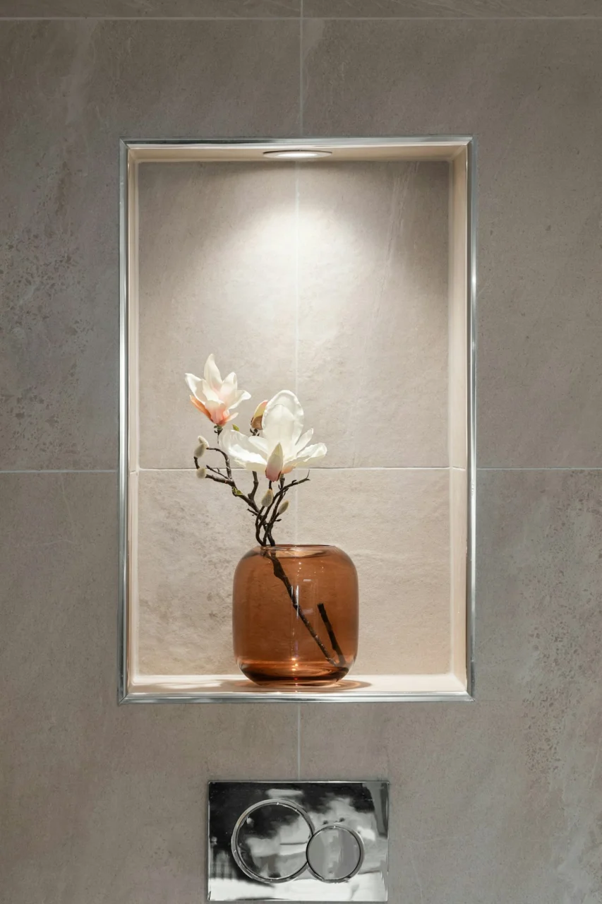 A vase with flowers in it sitting on a shelf
