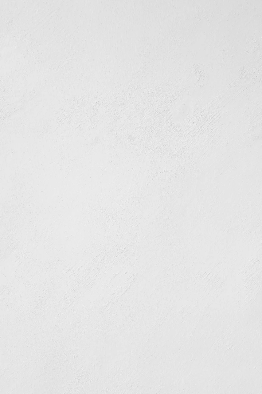 A white wall with a subtle plaster texture