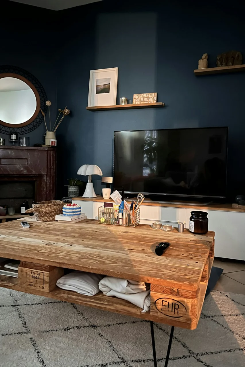 a wooden table with a television and a mirror