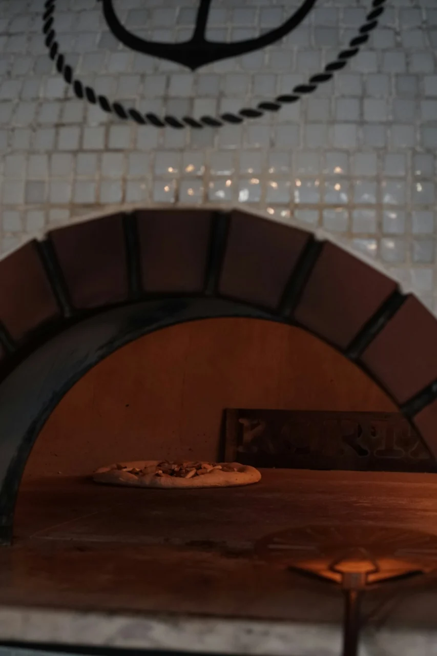 an oven with a pizza inside of it