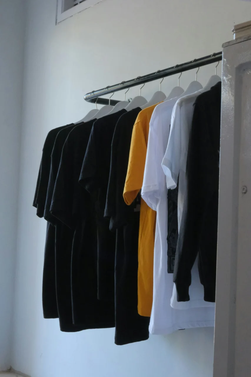 Assorted t-shirts hanging on a rack
