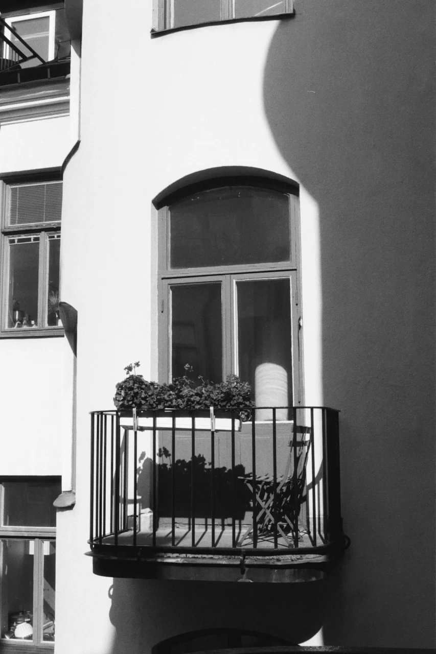 black metal fence near white concrete building