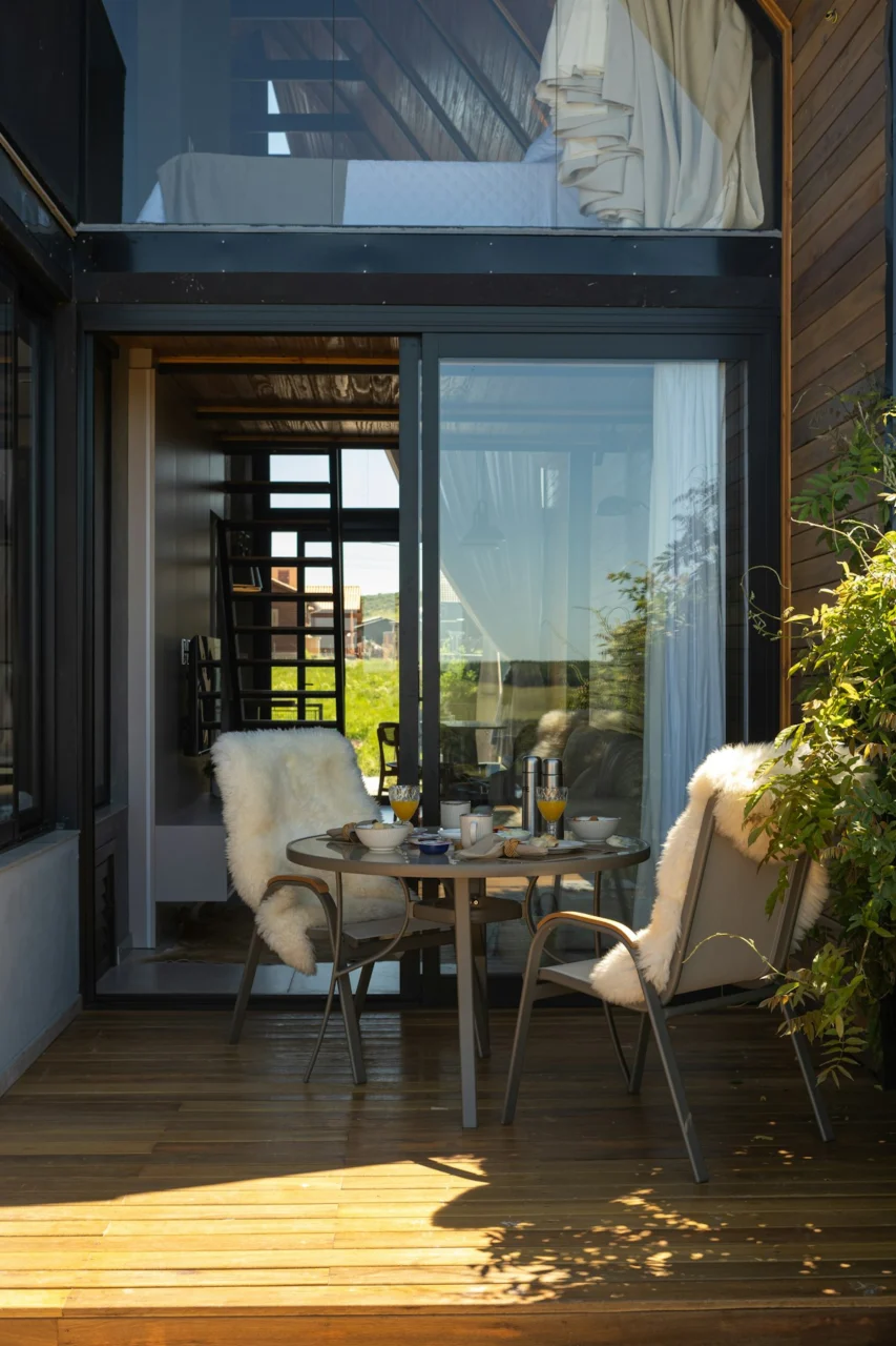 Cozy outdoor seating area with breakfast table and lush greenery