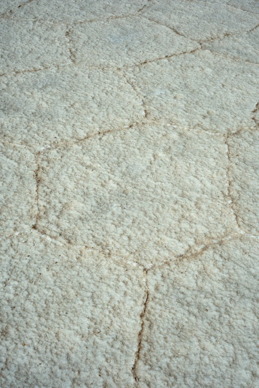 Cracked salt flat texture with hexagonal patterns
