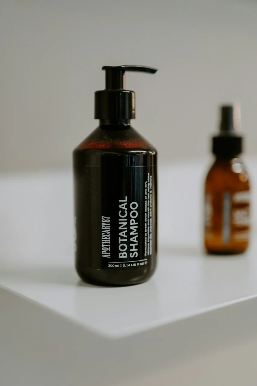 Dark bottle of botanical shampoo with pump dispenser