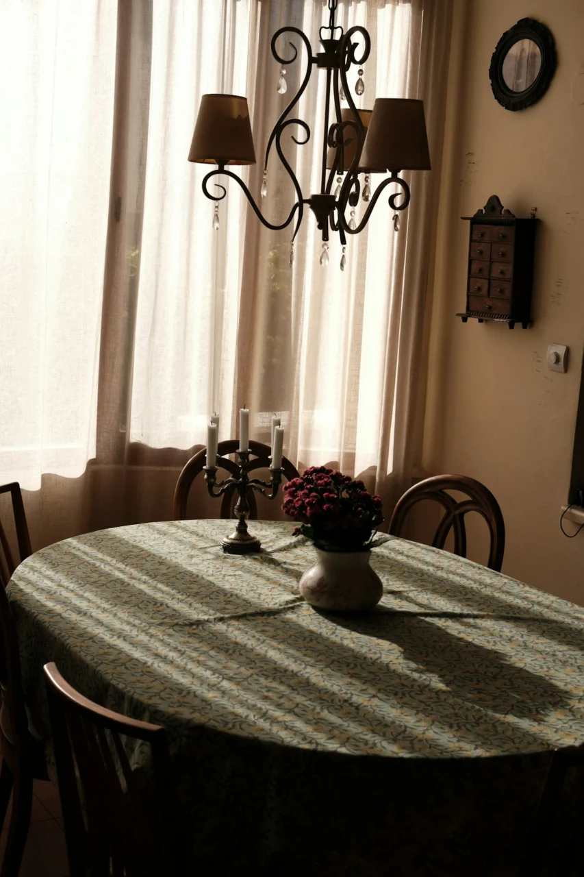 Dining table with chandelier and flower vase