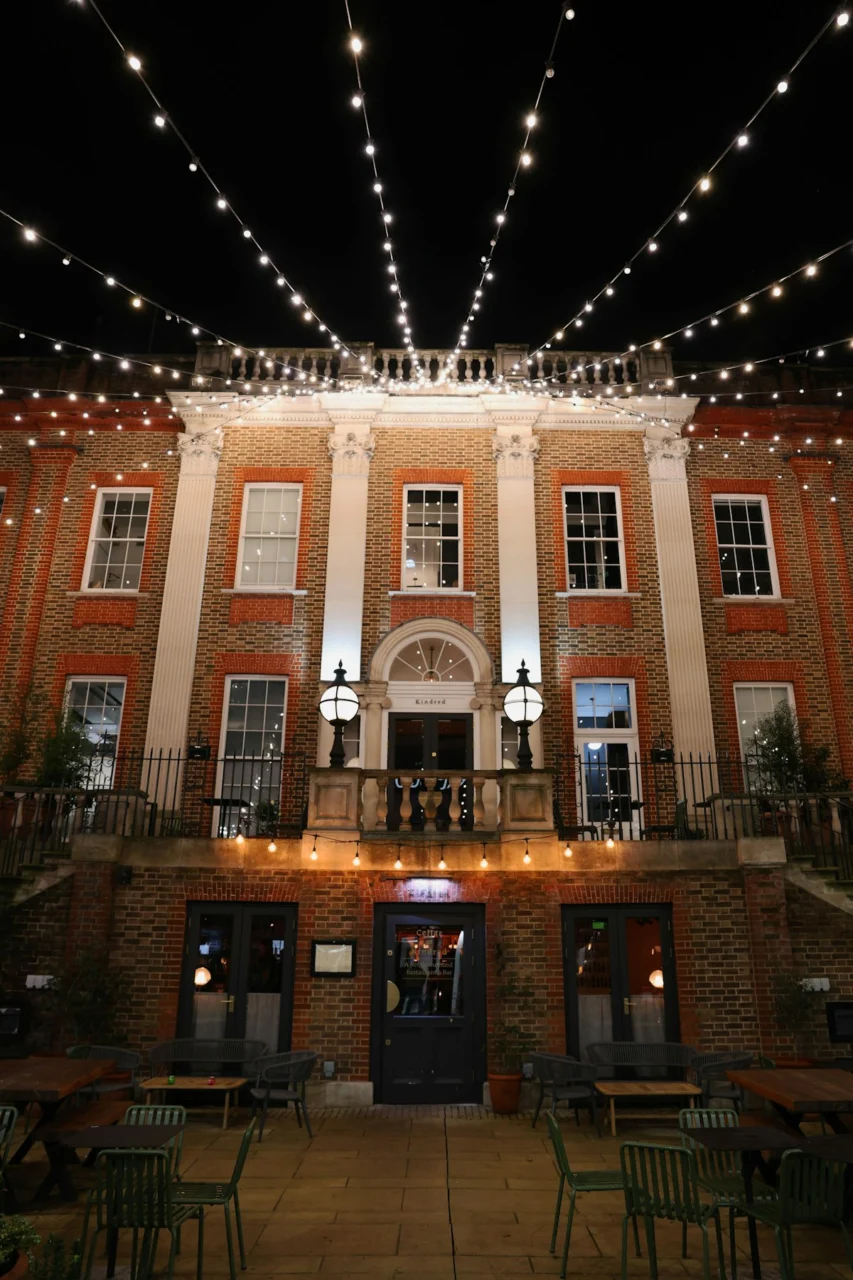Elegant building facade decorated with string lights at night