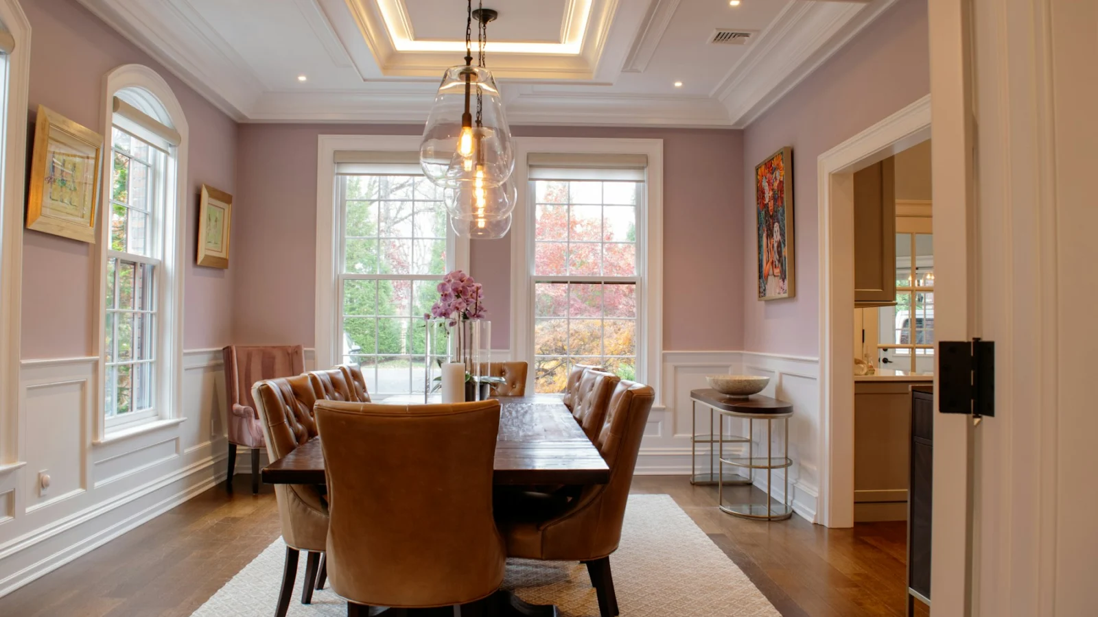 Elegant dining room with plush chairs and modern chandelier