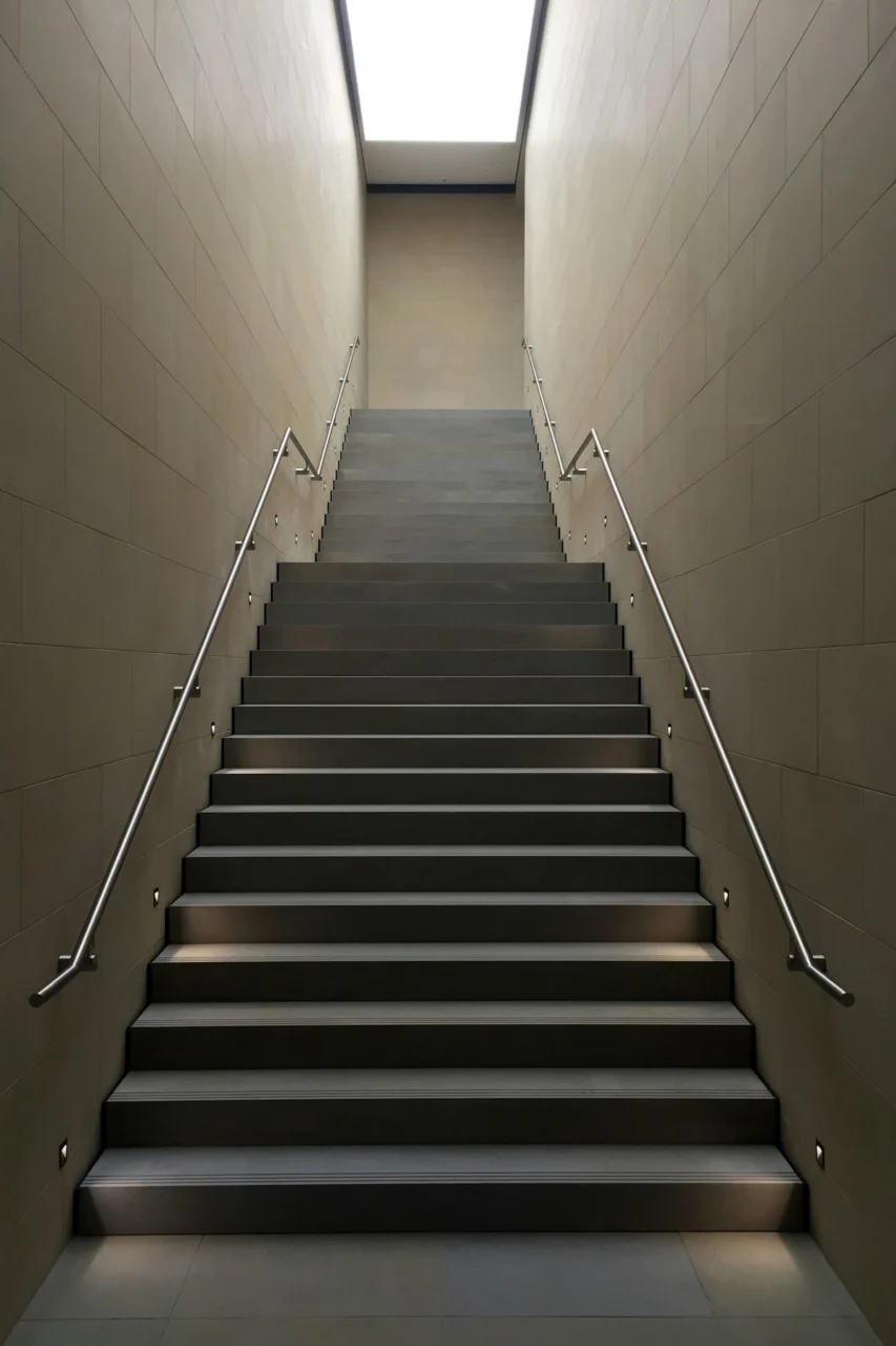 gray concrete stair with gray steel handle